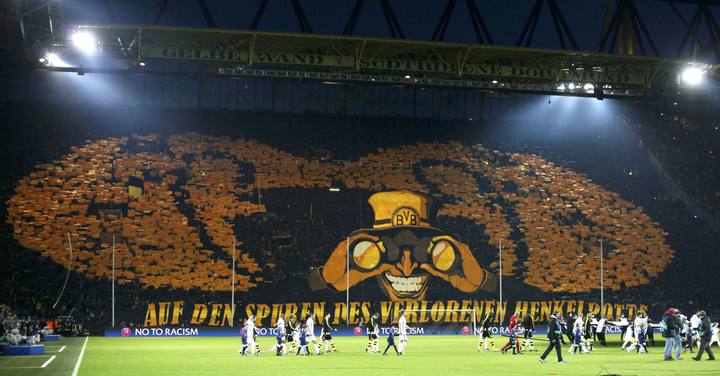 Borussia Dortmund fans hold up placards and a banner which reads 'In the footsteps of the lost cup', before the Champions League quarter-final second leg soccer match against Malaga, in the western German city of Dortmund April 9, 2013.        REUTERS/Wolfgang Rattay (GERMANY  - Tags: SPORT SOCCER)